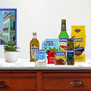 Various Goya products on table top with a pot of plant and wall art next to it